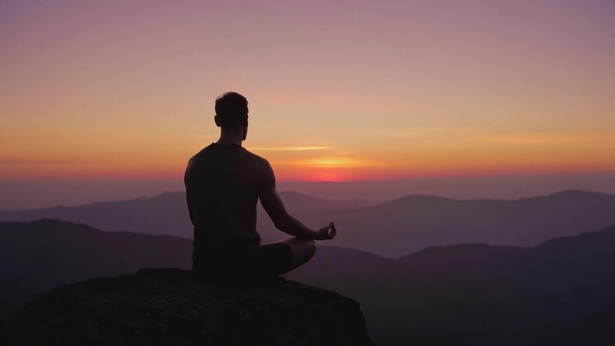 Person practicing mindful movement outdoors at sunrise, demonstrating natural daily rhythm